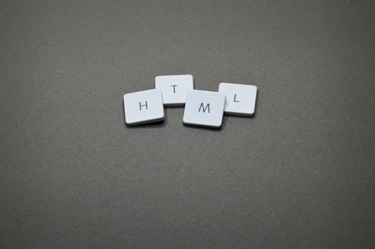 Minimalist image of HTML keycaps against a gray background, perfect for digital and web design themes.